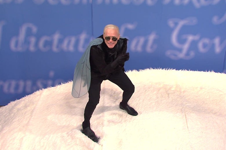 Jim Carrey as Joe Biden, wearing a fly costume, atop a giant white fuzzy floor meant to evoke Mike Pence's hair.