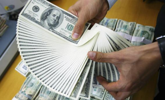 An employee of the Korea Exchange Bank counts U.S. dollars at the bank's headquarters