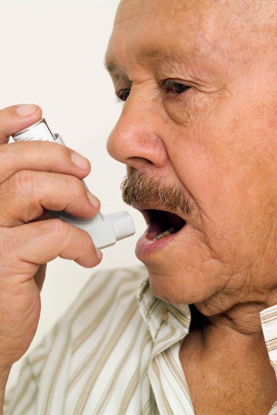 Man using an asthma inhaler.