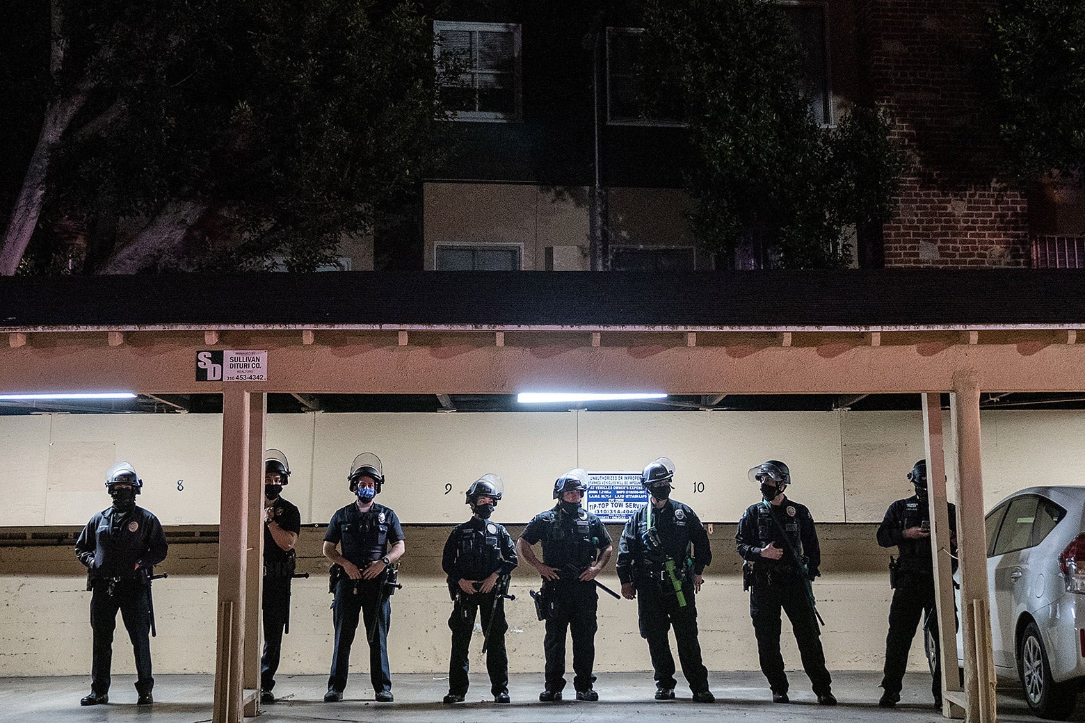 Police are seen standing inside a parking garage.