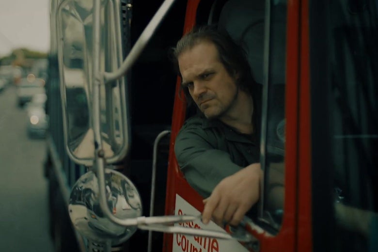 David Harbour sticks his head out of a garbage truck like Joaquin Phoenix in Joker.