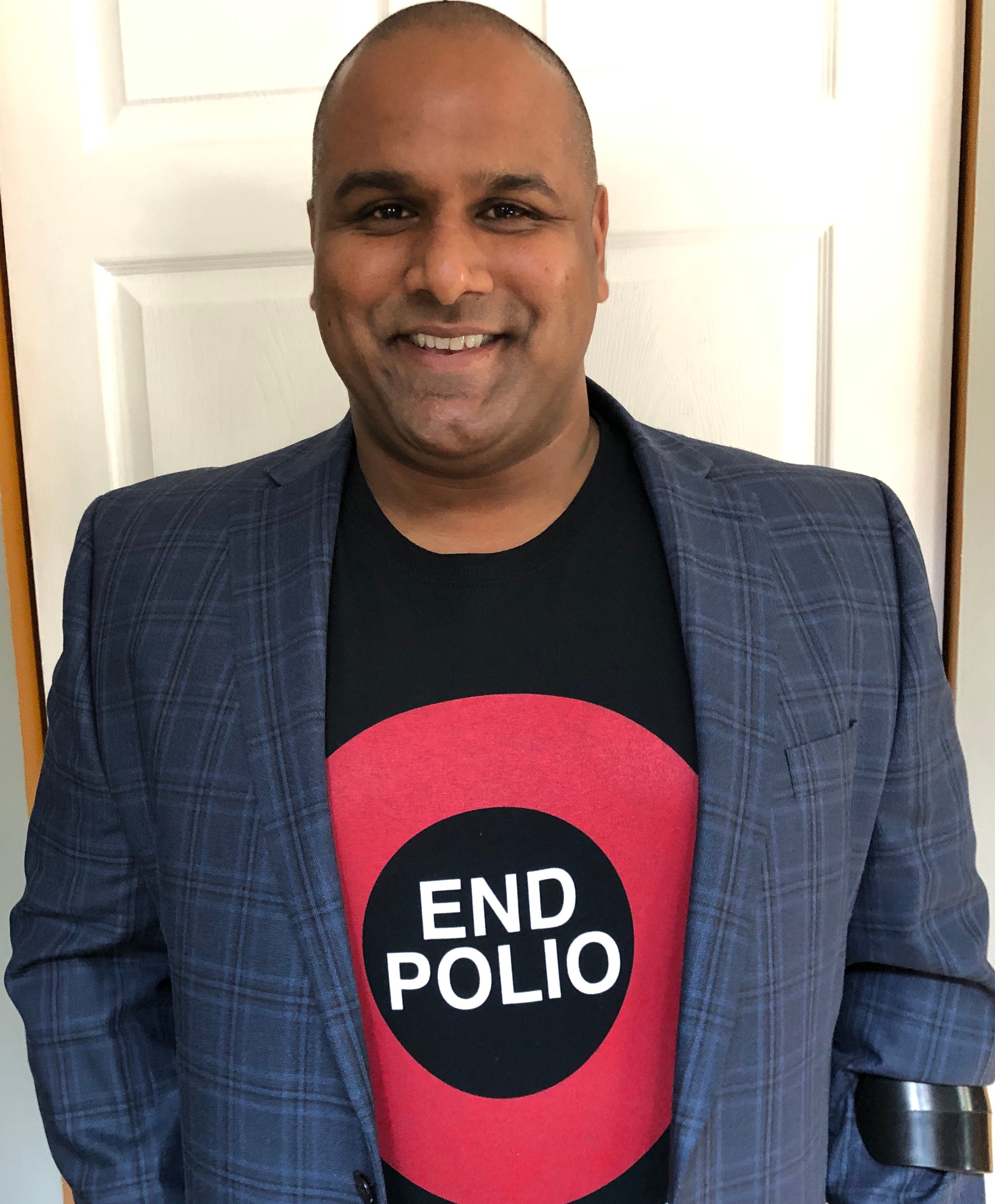 A picture of Ramesh Ferris wearing a shirt that says end polio