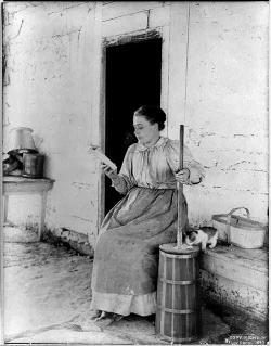 Woman churning milk to butter, 1897.