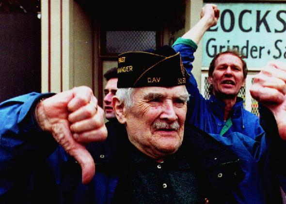 Spectators react to the Irish American Gay, Lesbian, and Bisexual Group of Boston during their appearance in the 1993 South Boston St. Patrick's Day Parade.