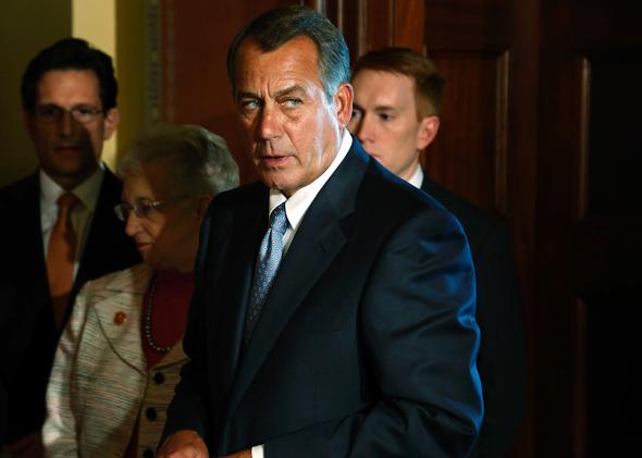 House Speaker John Boehner (R-OH) (C) takes the lectern to speak at a news conference with fellow House Republican leaders.