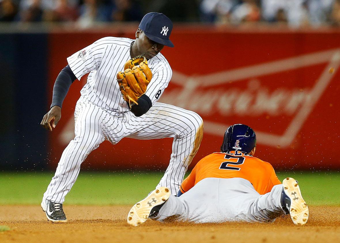 Jonathan Villar #2 of the Houston Astros steals against Didi Gregorius #18 of the New York Yankees during the American League Wild Card Game at Yankee Stadium on October 6, 2015 in the Bronx borough of New York City, New York.
