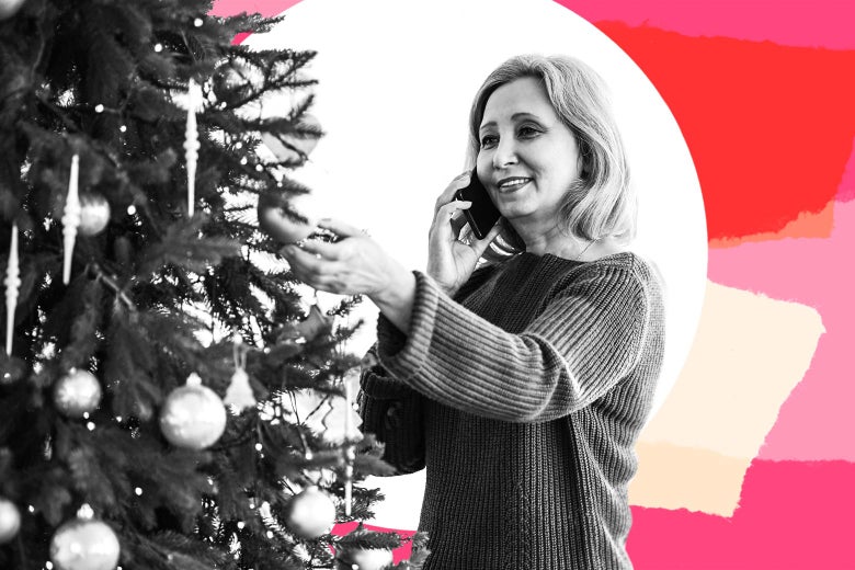 Woman decorating a Christmas tree while talking on the phone, smiling
