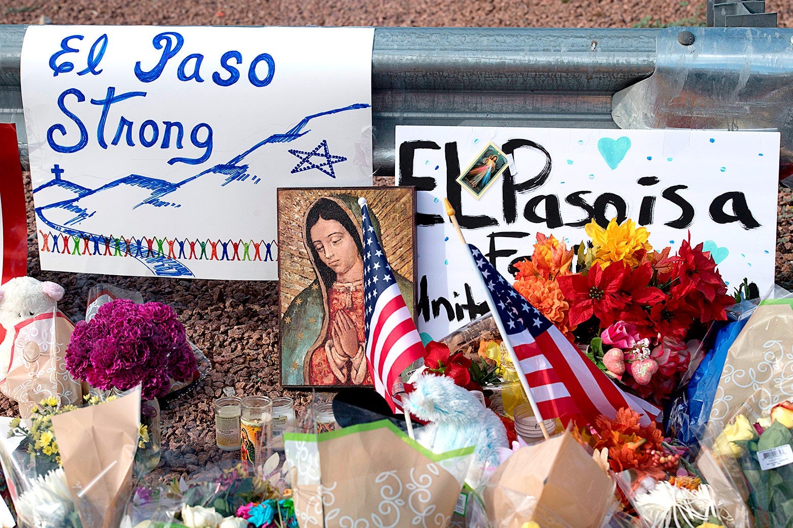 Flowers and signs are seen at a makeshift memorial on Monday after the shooting that left 21 people dead at the Cielo Vista Mall WalMart in El Paso, Texas. 