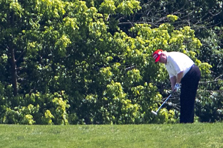 Trump golfs at Trump National Golf Club in Potomac Falls, Virginia.