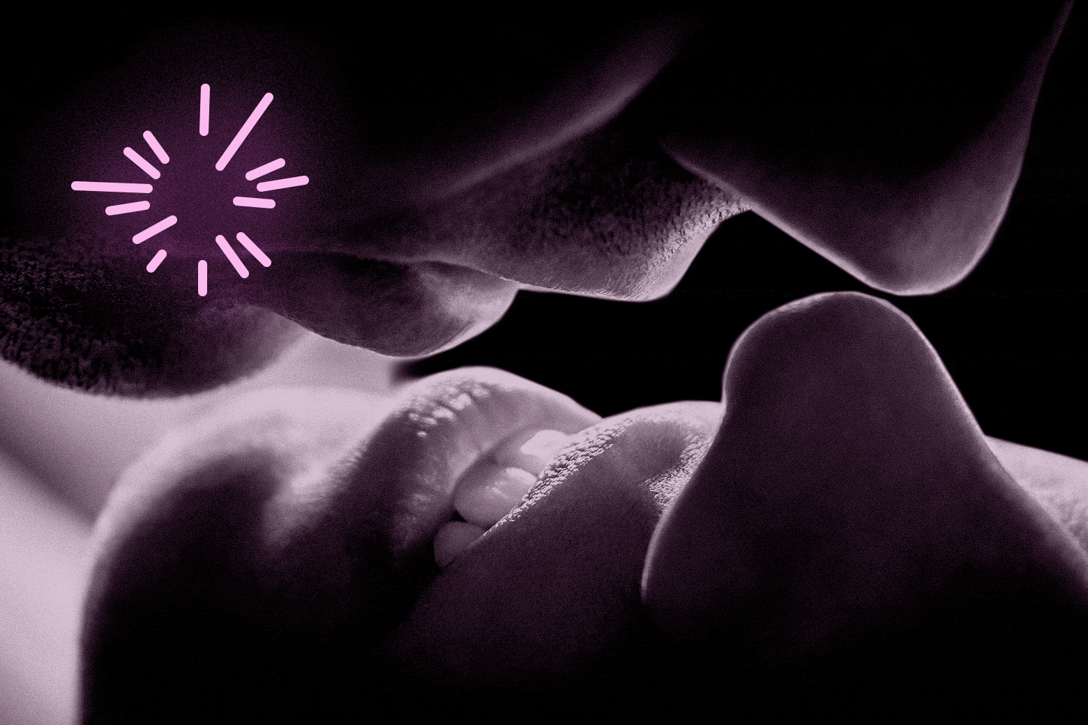 A close up of a man and woman kissing and having an intimate mouths touching moment with pink fireworks exploding. 