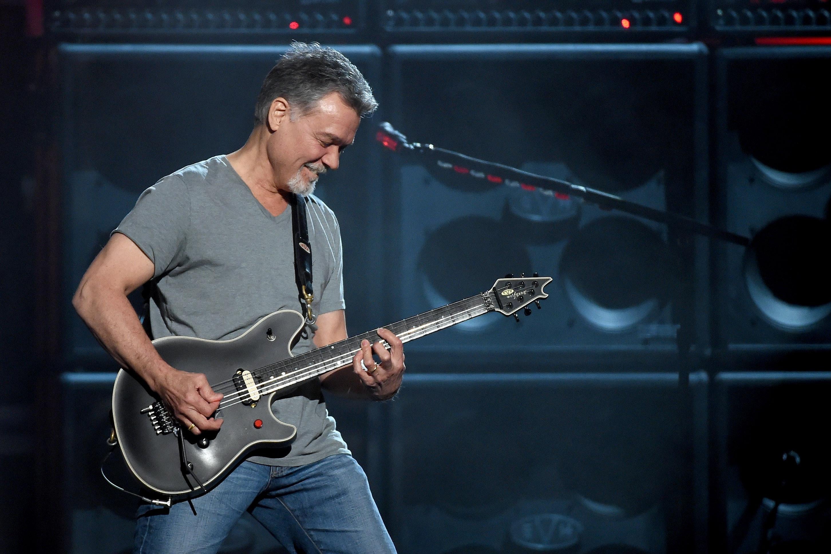 Guitarist Eddie Van Halen playing a black guitar onstage in Las Vegas.
