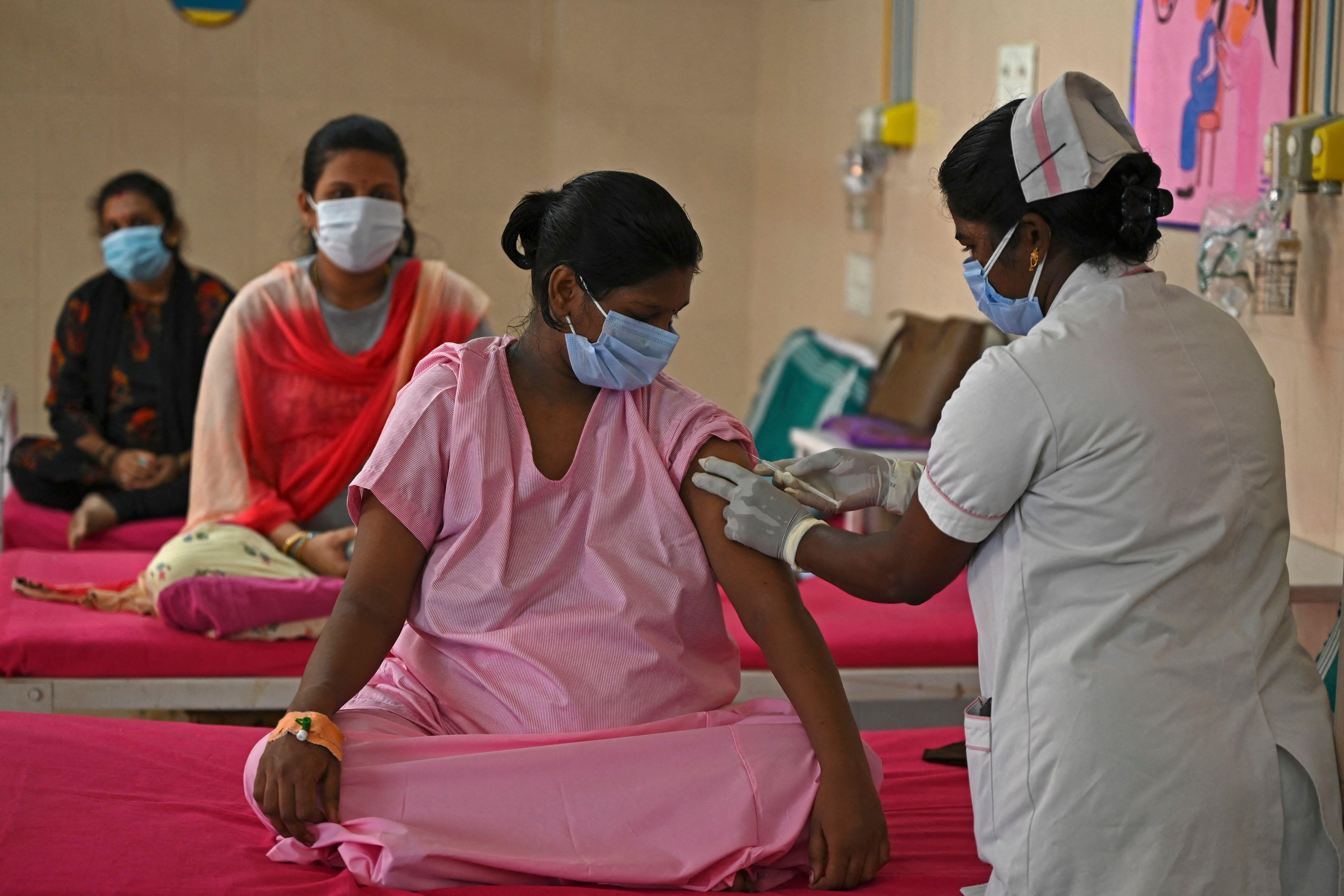 A pregnant woman gets inoculated with a dose of the Covaxine vaccine against the Covid-19 coronavirus at a government maternity and child hospital in Chennai on July 5, 2021. (Photo by Arun SANKAR / AFP) (Photo by ARUN SANKAR/AFP via Getty Images)