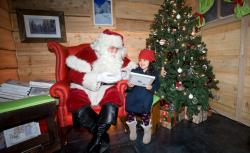 Children speak to Santa after being the first to board.