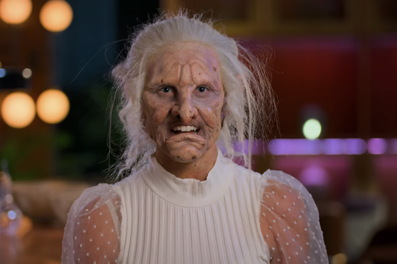 Woman in white tank top with a troll head.
