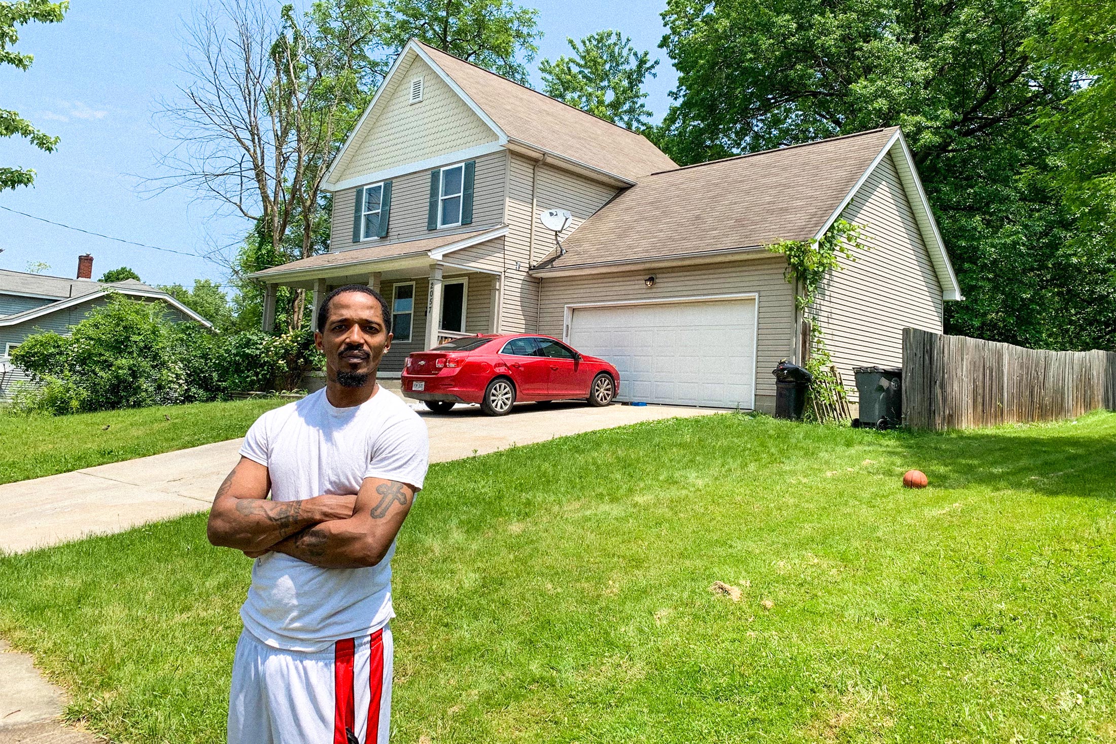 Tre Lewis stands in his front yard.