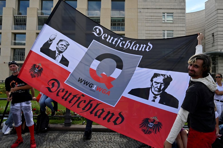 A flag featuring QAnon iconography and pictures of Trump.