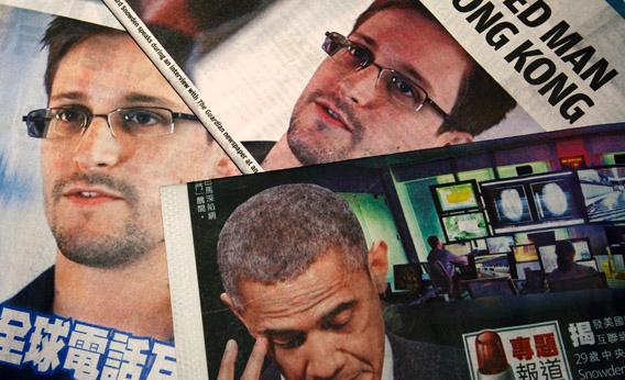 Photos of Edward Snowden, a contractor at the National Security Agency (NSA), and U.S. President Barack Obama are printed on the front pages of local English and Chinese newspapers in Hong Kong