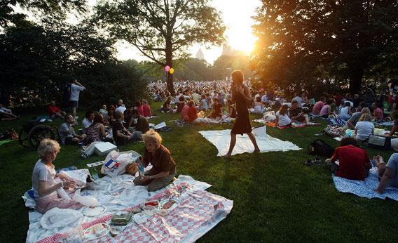 People gather before a free concert in Central Park by the New York Philharmonic