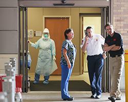Health care workers wait for the arrival of a possible Ebola patient at the Texas Health Presbyterian Hospital on Oct. 8, 2014, in Dallas