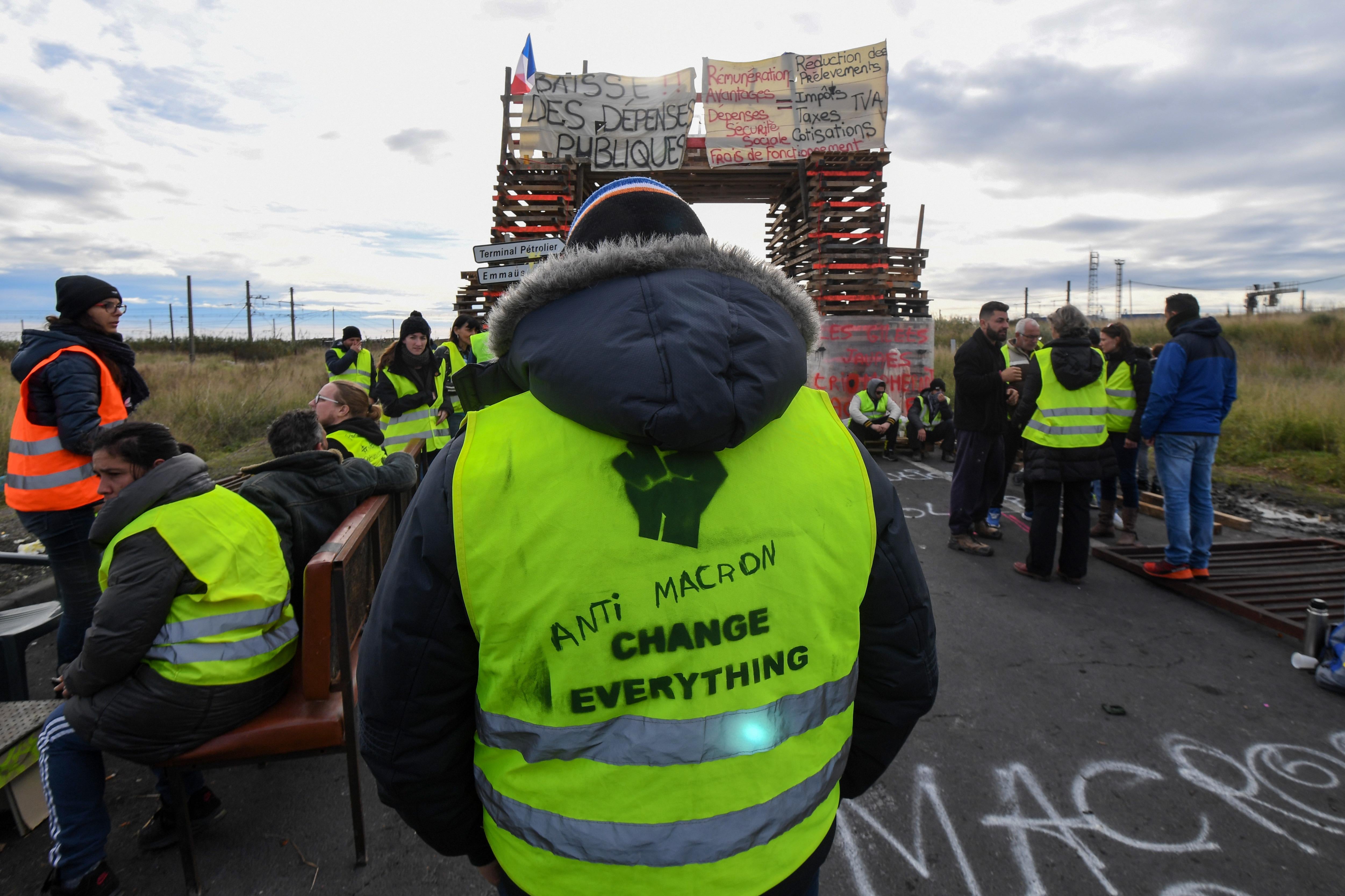 Yellow vests (Gilets jaunes) protesters block the road leading to the Frontignan oil depot in the south of France, as they demonstrate  against the rise in fuel prices and the cost of living on December 3, 2018. - Dozens of French 'yellow vest' demonstrators blocked access to a major fuel depot and several highways on the third week of anti-government protests which led to major riots in Paris at the weekend. (Photo by PASCAL GUYOT / AFP)        (Photo credit should read PASCAL GUYOT/AFP/Getty Images)