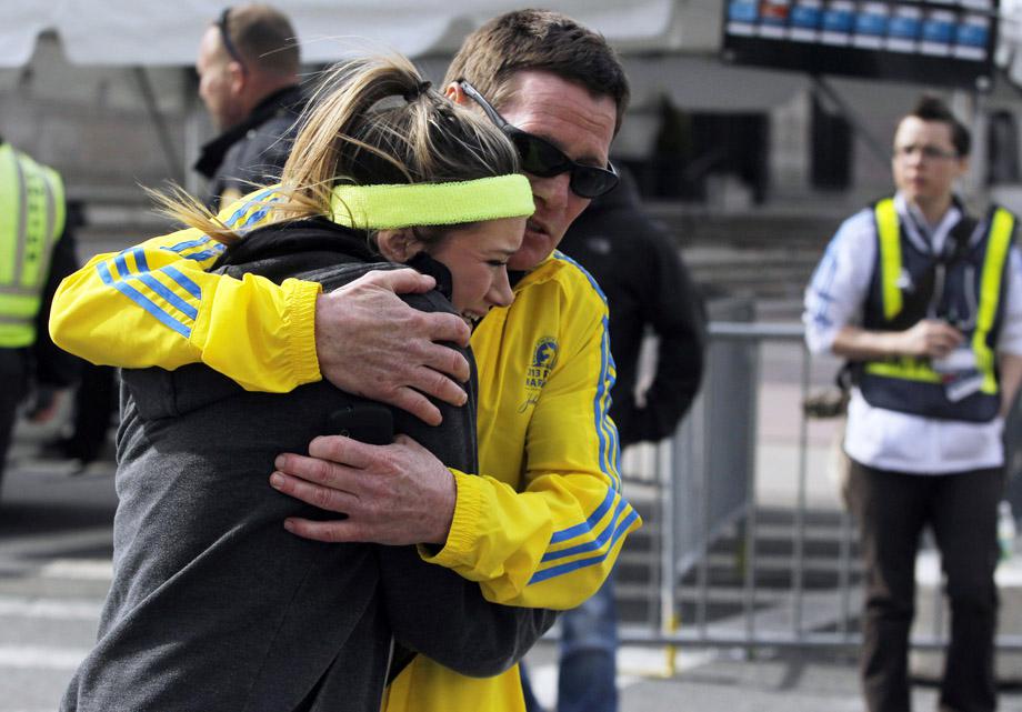 A woman is comforted by a man near a triage tent set up for the Boston Marathon after explosions went off at the 117th Boston Marathon.