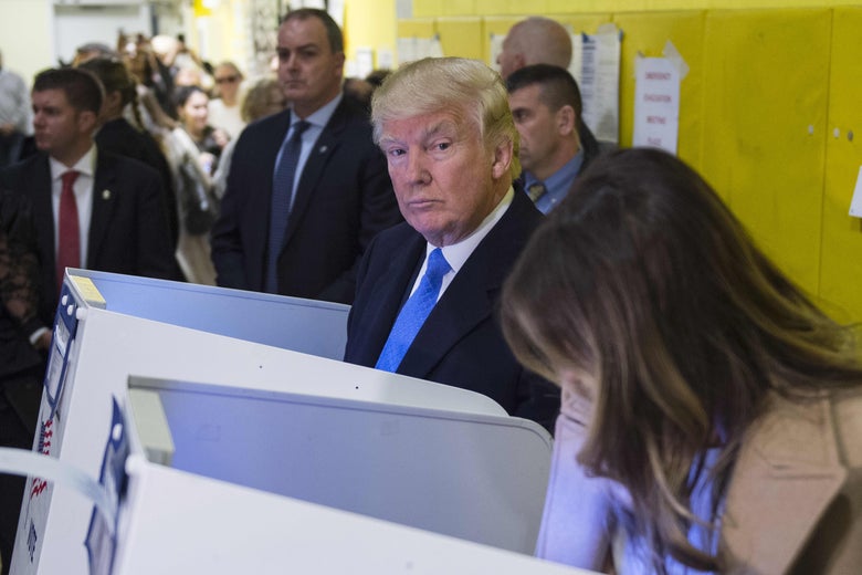 Trump looks up from the ballot booth while voting in 2016.
