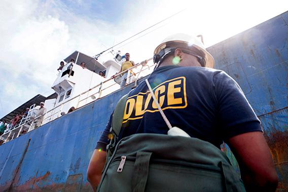 A week after encountering the tuna-laundering boats, officer Earl Benhart of Palau's Marine Police prepares to board the Sal 19, a fishing vessel transiting through Palauan waters.