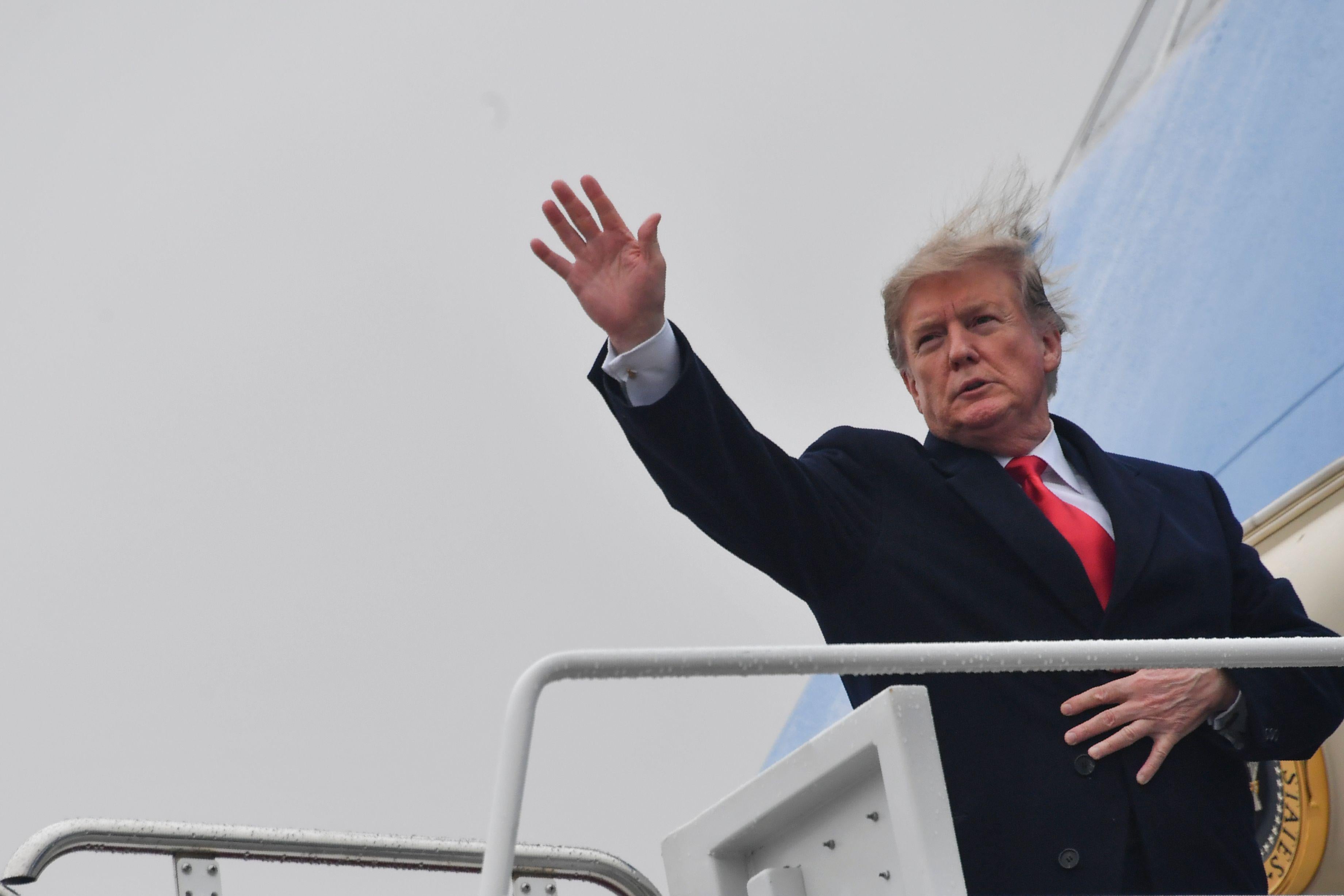 President Trump waves as he boards Air Force One.