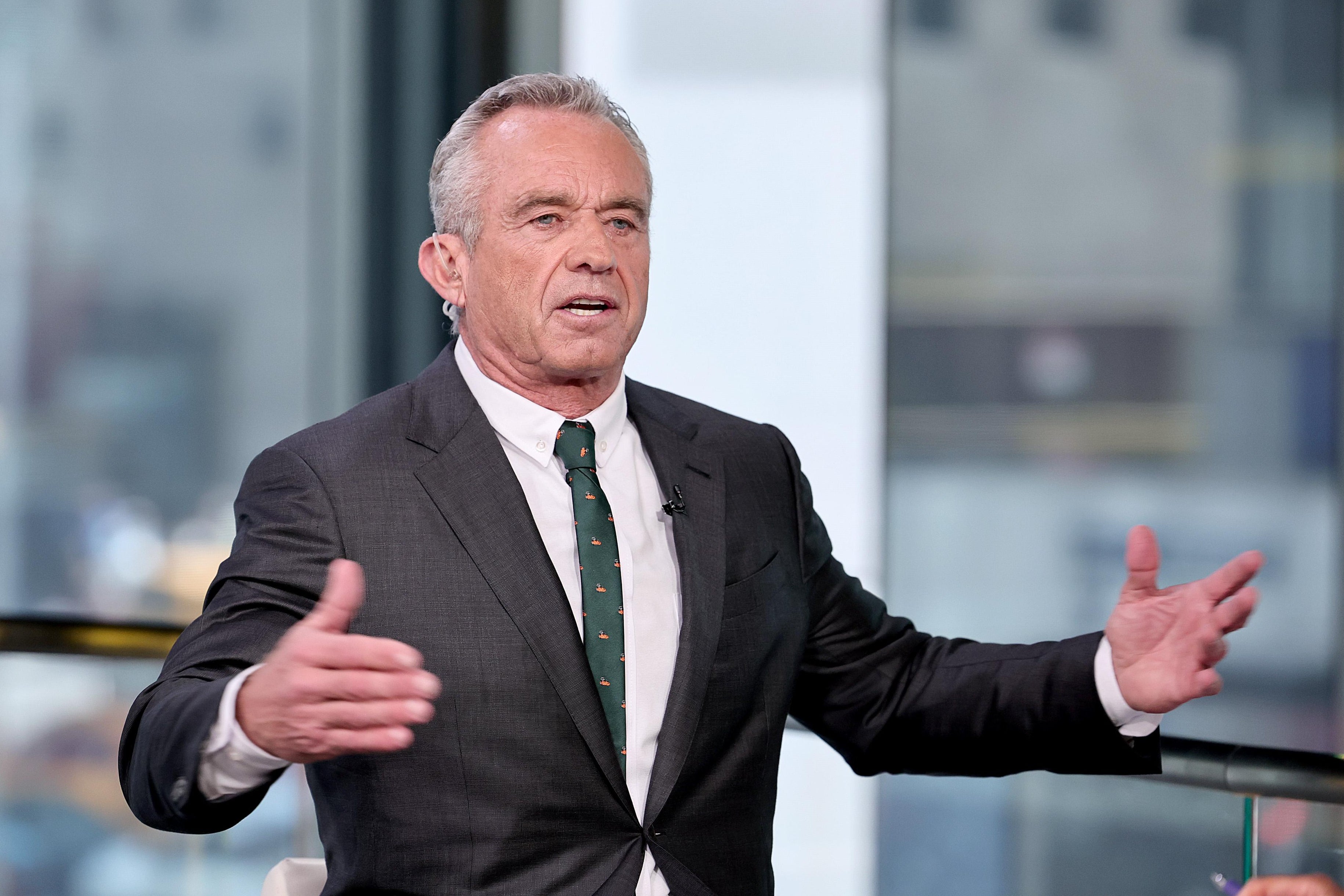 Robert F. Kennedy Jr. with his arms extended as he speaks