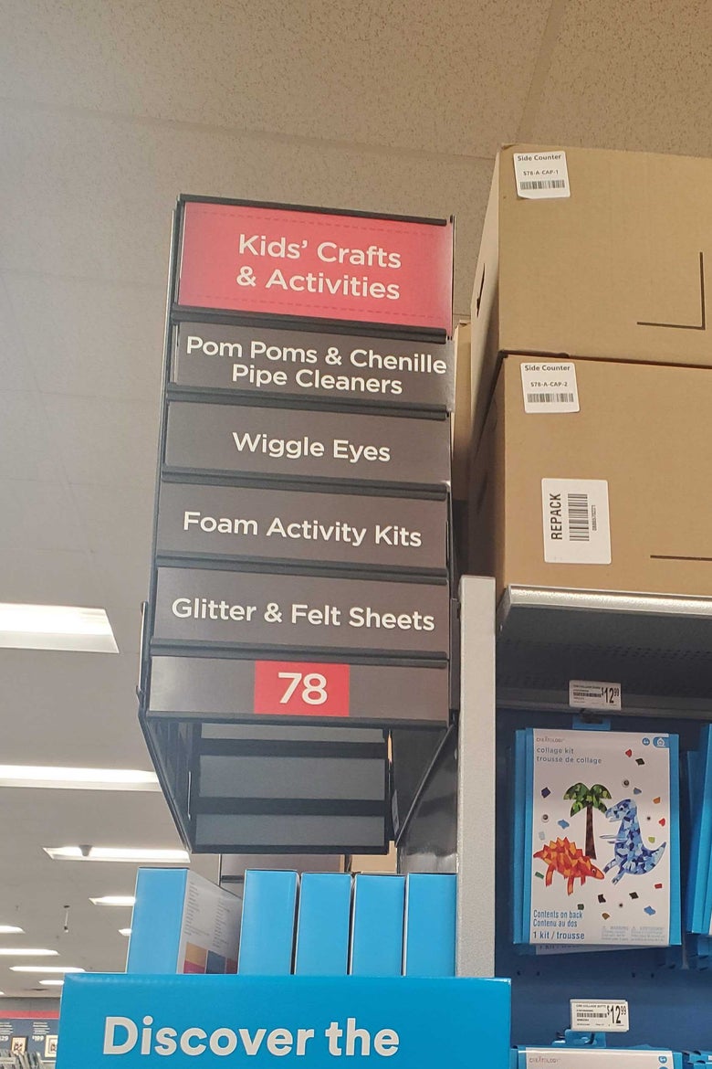 The sign for Aisle 78 at a Brooklyn Michaels, which lists "Wiggle Eyes" among its offerings.