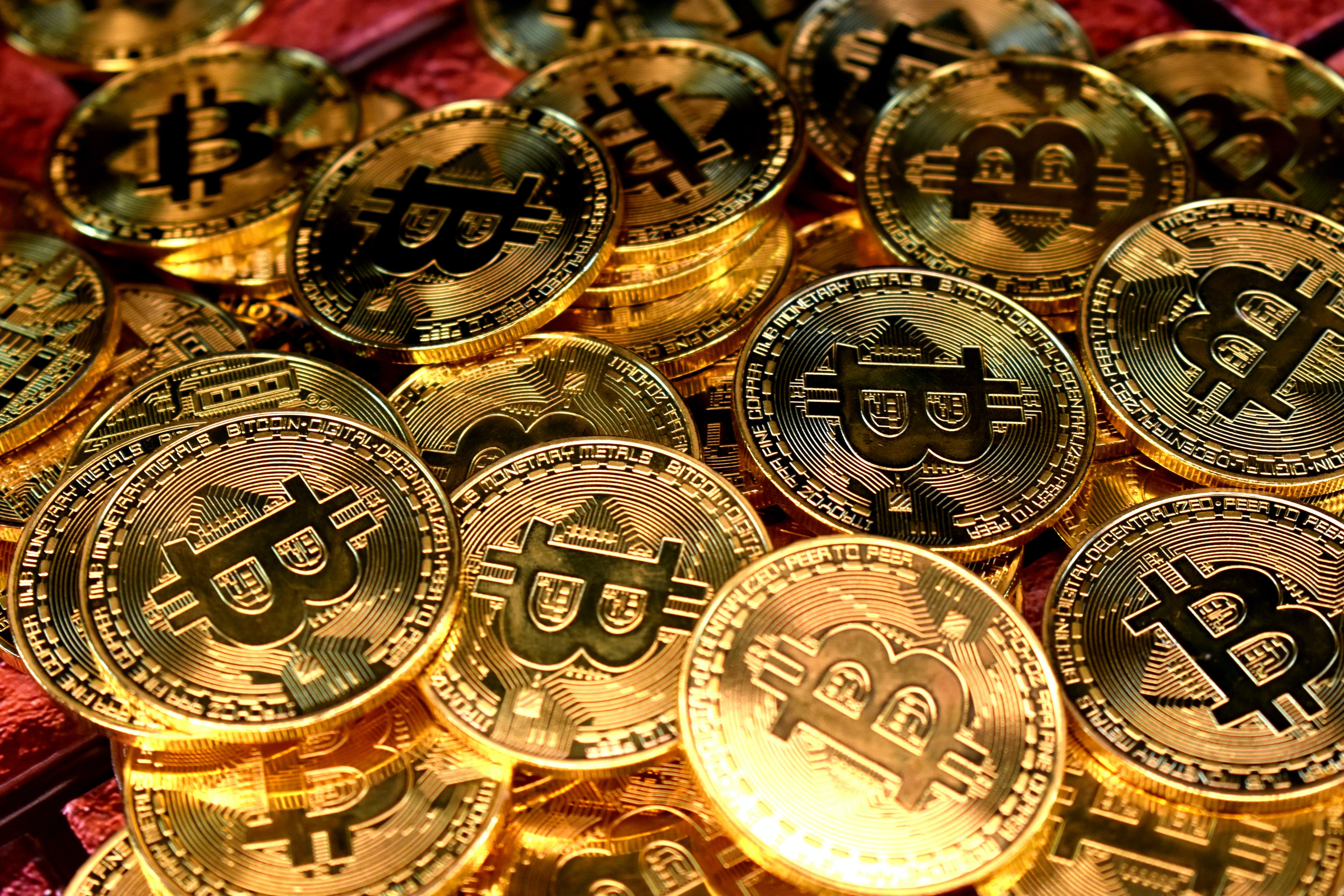 A pile of golden coins with the Bitcoin logo.