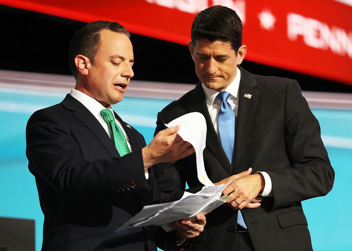 Reince Priebus, chairman of the Republican National Committee, and Speaker of the House Paul Ryan consult one another about the recount of Alaska delegation votes after roll call on the second day of the Republican National Convention on July 19, 2016 at the Quicken Loans Arena in Cleveland, Ohio. 