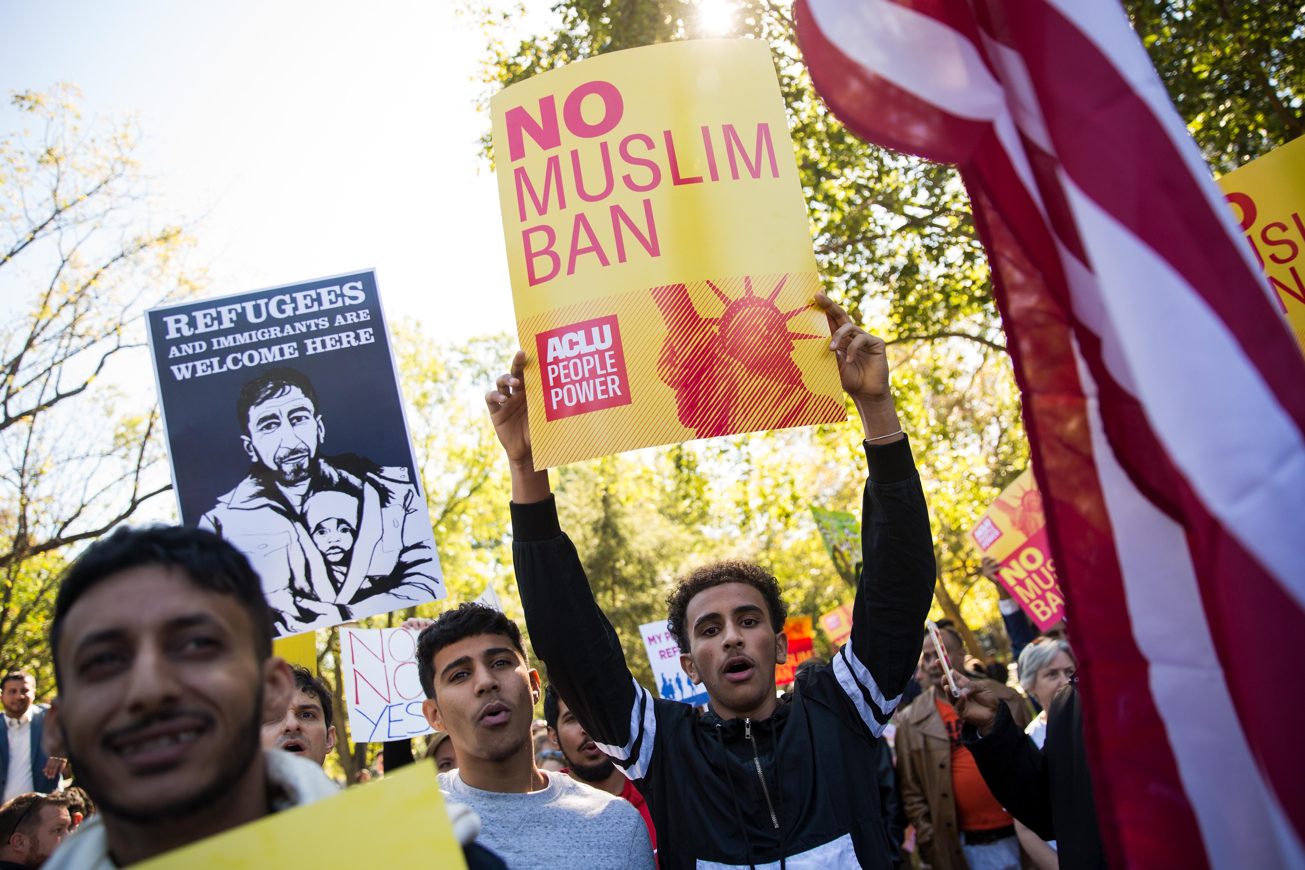 WASHINGTON, DC - OCTOBER 18: Activists rally in Lafayette Park during a protest against the Trump administration's proposed travel ban, October 18, 2017 in Washington, DC. Early Wednesday morning, a federal judge in Maryland granted a motion for a preliminary injunction on the administration's travel ban. This is the Trump administration's third attempt to restrict entry into the United States for citizens from mostly Muslim-majority countries. The Department of Justice said it plans to appeal and the White House issued a statement calling the judge's decision 'dangerously flawed.' (Photo by Drew Angerer/Getty Images)