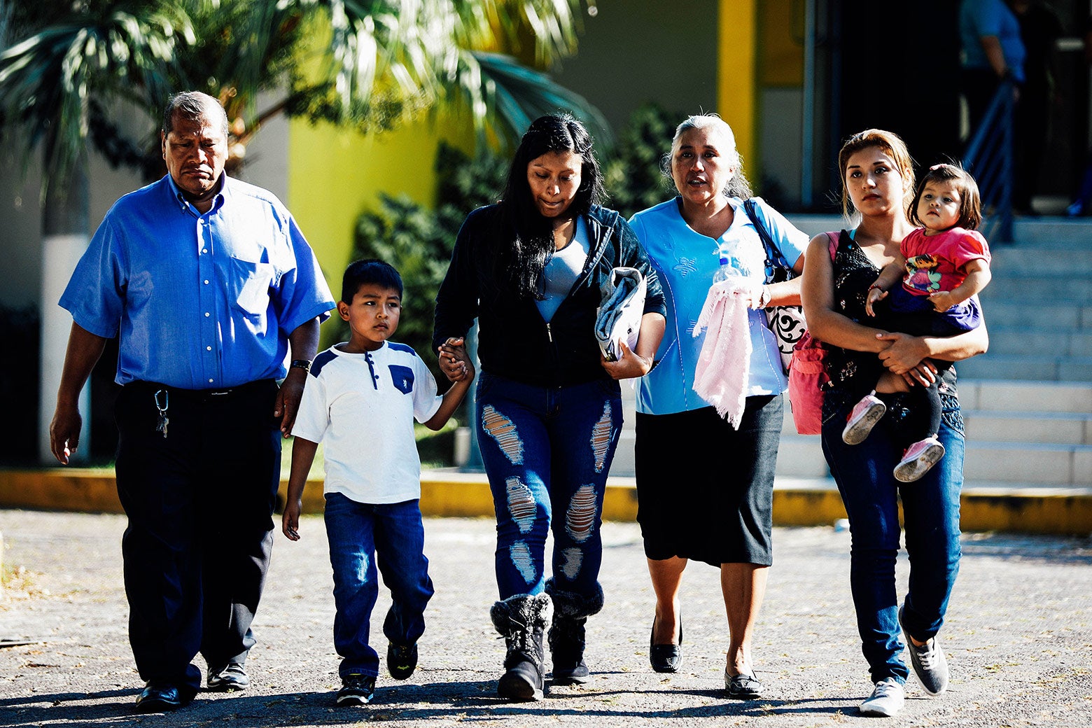 A deportee walks out with her family at an immigration facility in San Salvador, El Salvador, on Jan. 11.