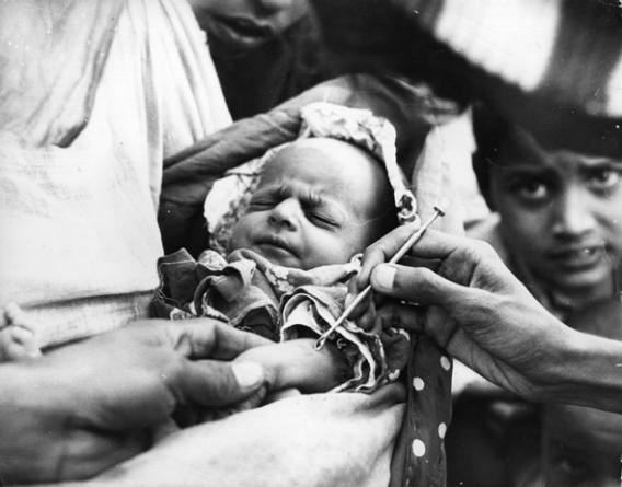 A baby is vaccinated against smallpox at an emergency clinic in Karachi during the worst epidemic of smallpox in Pakistan's history, January 1962. 