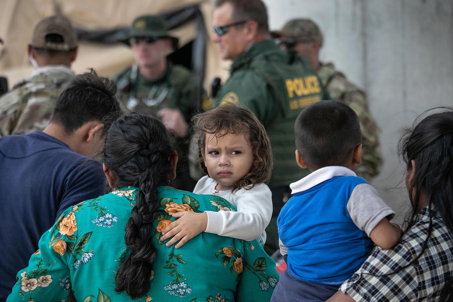 Immigrants waiting to be interviewed by U.S. Border Patrol agents after they were taken into custody in McAllen, Texas.