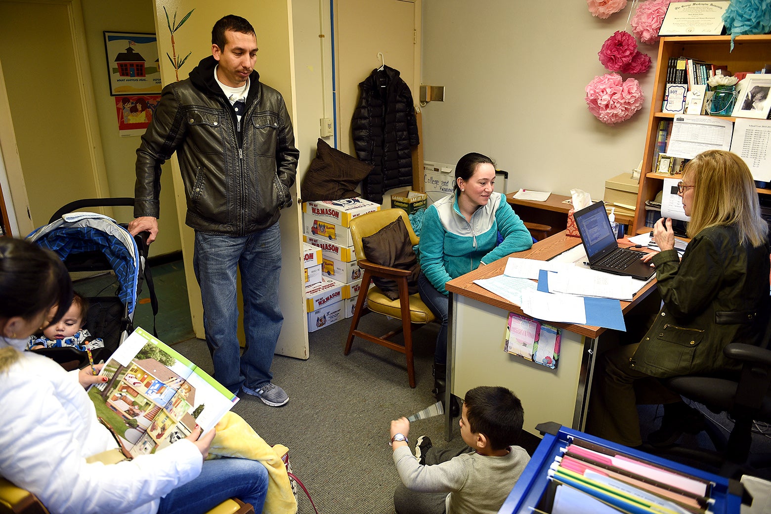 Maura Salguero, sitting, center, processes her daughter Jennifer Garcia Salguero, 12, left, at the International Student Counseling Office at the Judy Hoyer Learning Center of Cool Spring Elementary School in Adelphi, MD on Jan. 13, 2016.