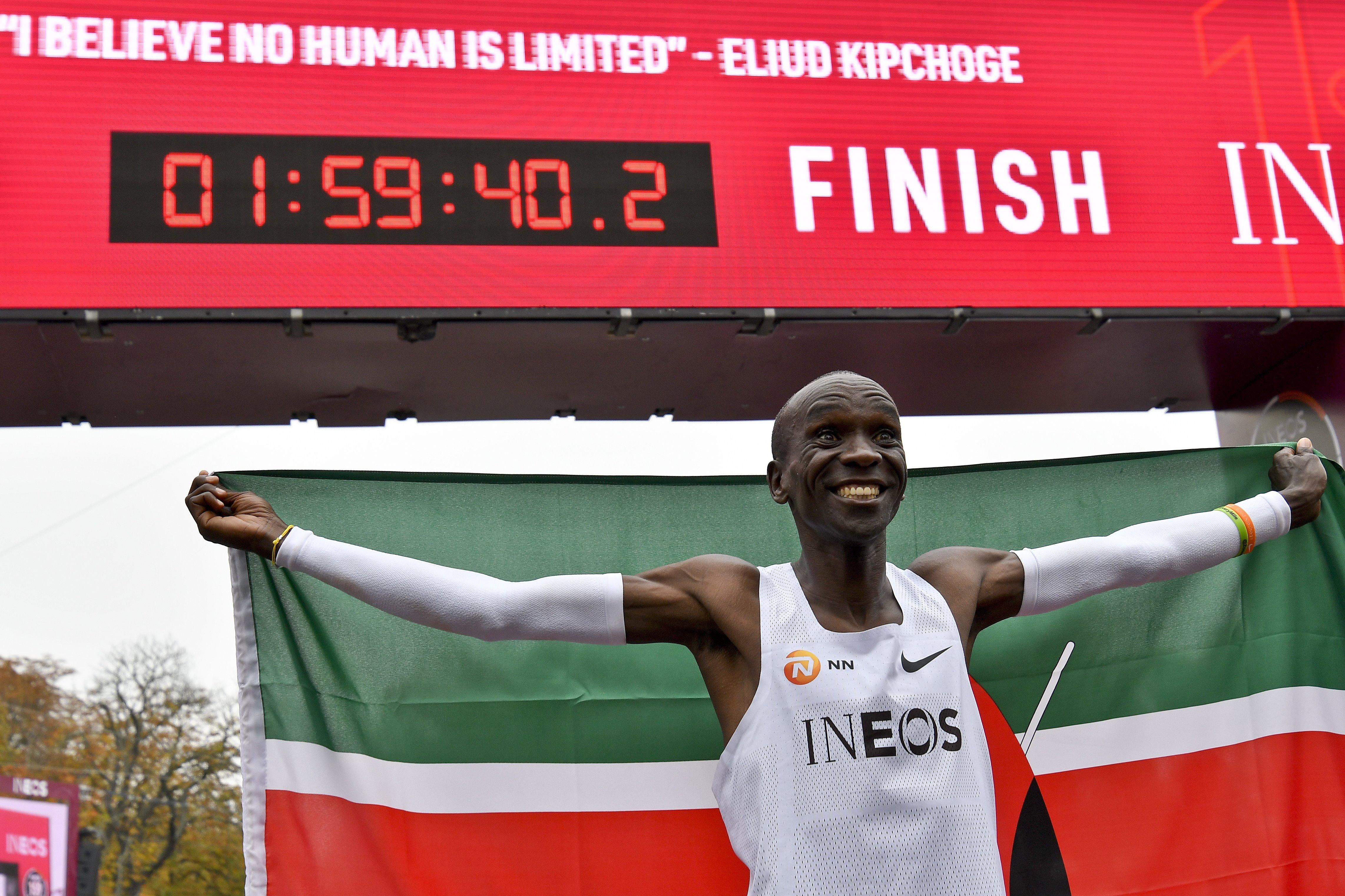 Kenya's Eliud Kipchoge celebrates after busting the mythical two-hour barrier for the marathon on October 12, 2019 in Vienna. 