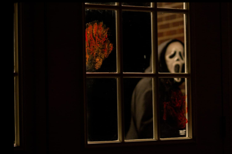 Ghostface behind a bloody window in Scream 4.