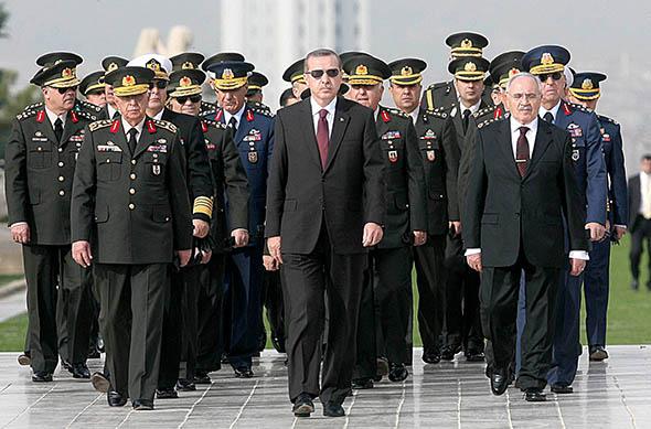 Turkish Prime Minister Tayyip Erdogan (C) attends a wreath-layin