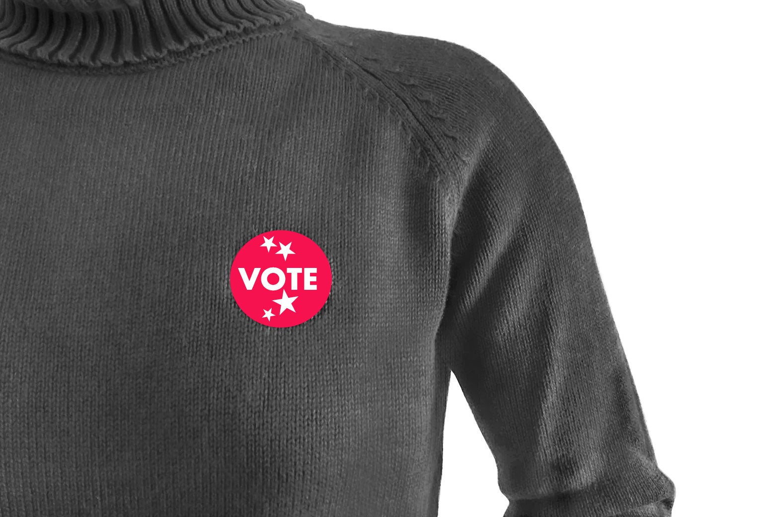 A sweater with a pink vote sticker on it.