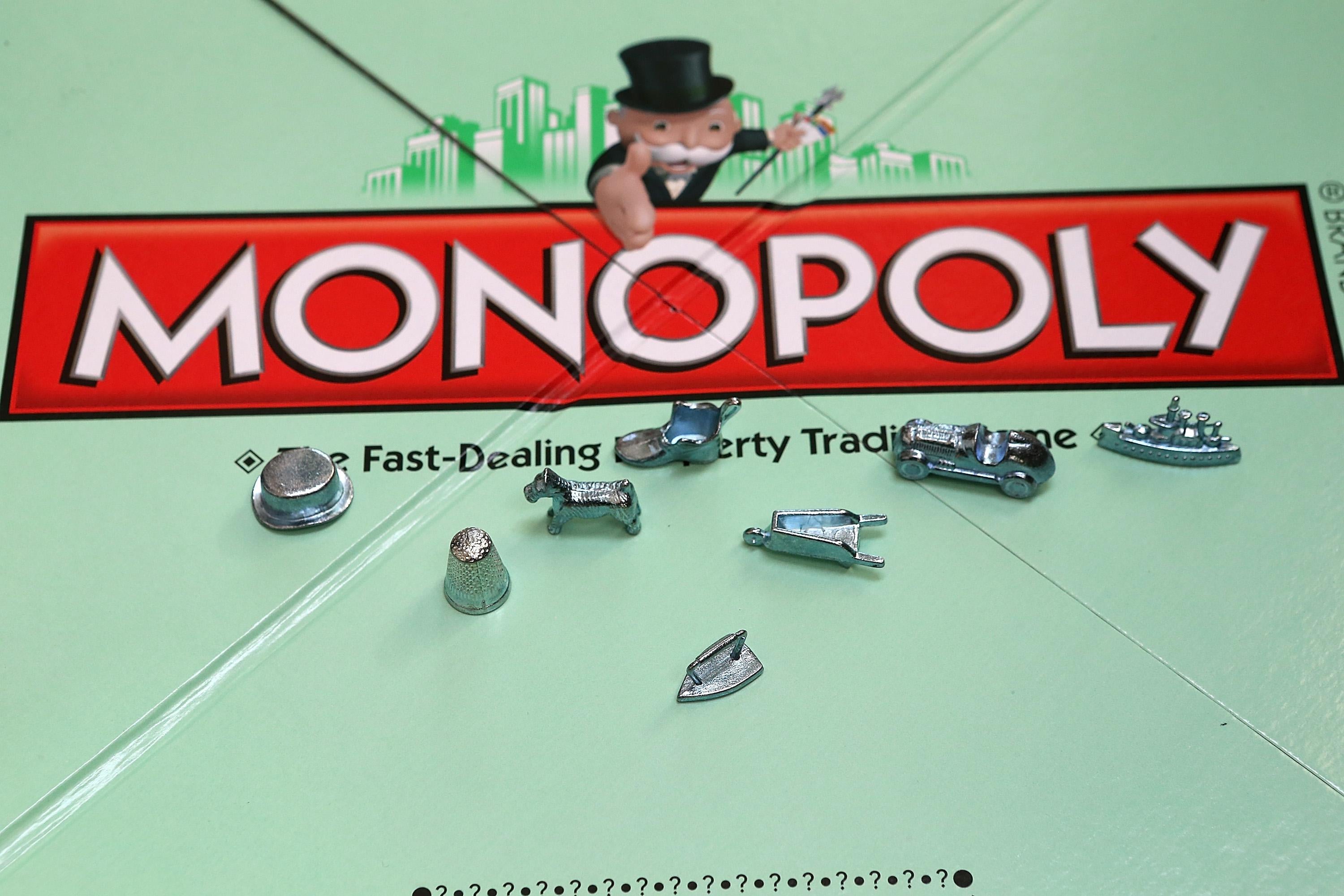 A traditional monopoly board with some of the game's famous tokens.