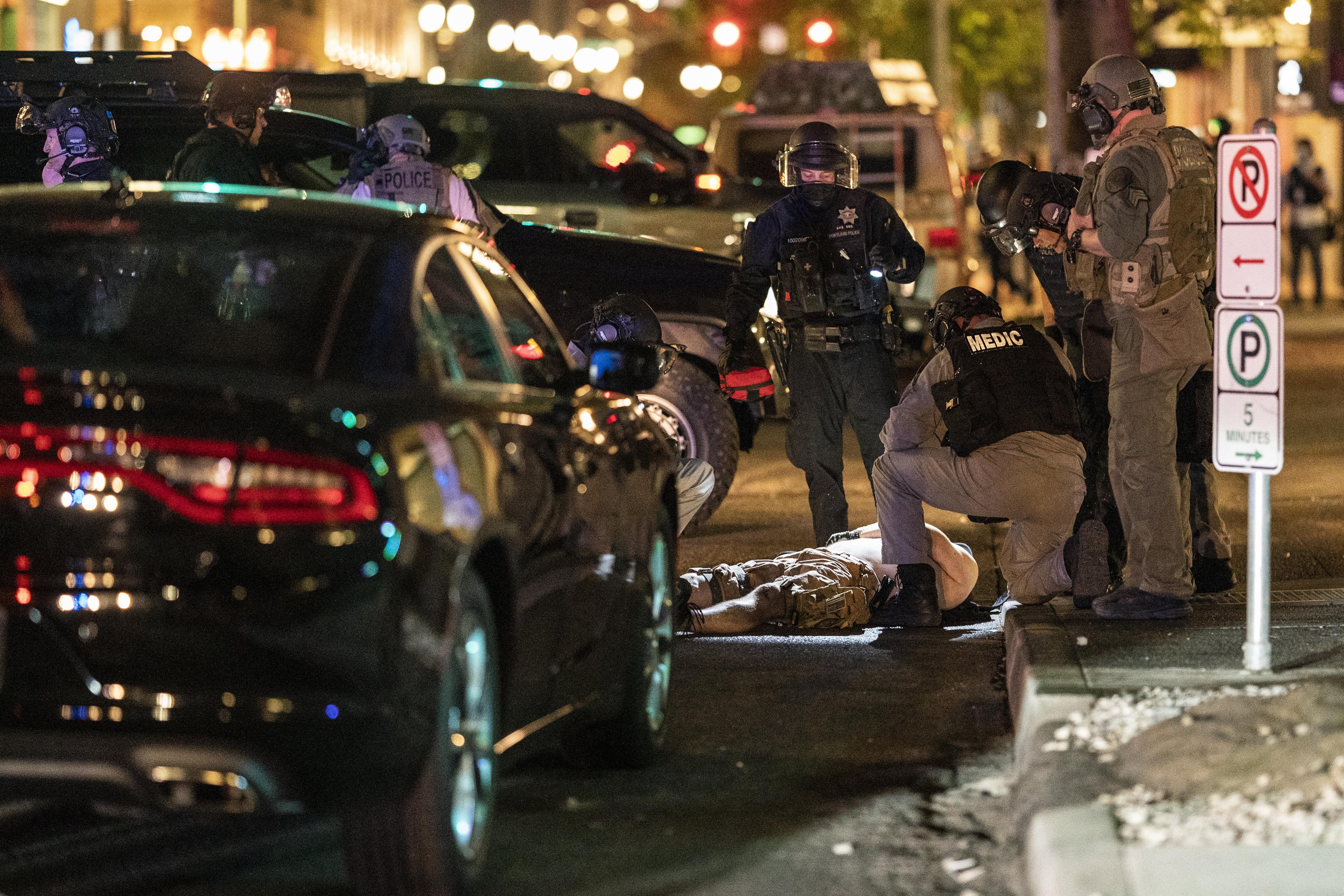 Police arrive to treat a man who was shot near a Pro-Trump rally on August 29, 2020 in Portland, Oregon.
