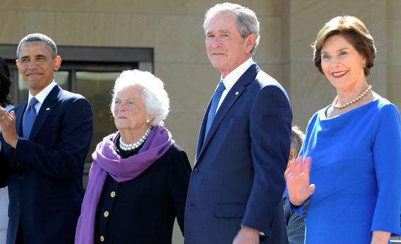US President Barack Obama, former First Lady Barbara Bush, former US President George H.W. Bush(hidden), former US President George W. Bush and Laura Bush stand on stage during the George W. Bush Presidential Center dedication ceremony in Dallas, Texas, on April 25, 2013. 