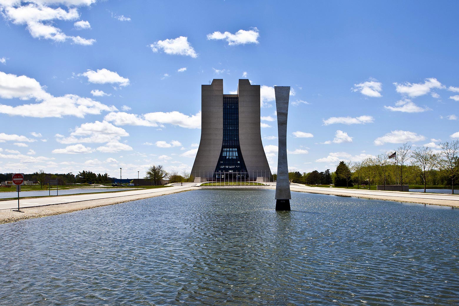 A water feature and sculpture outside the Fermilab.