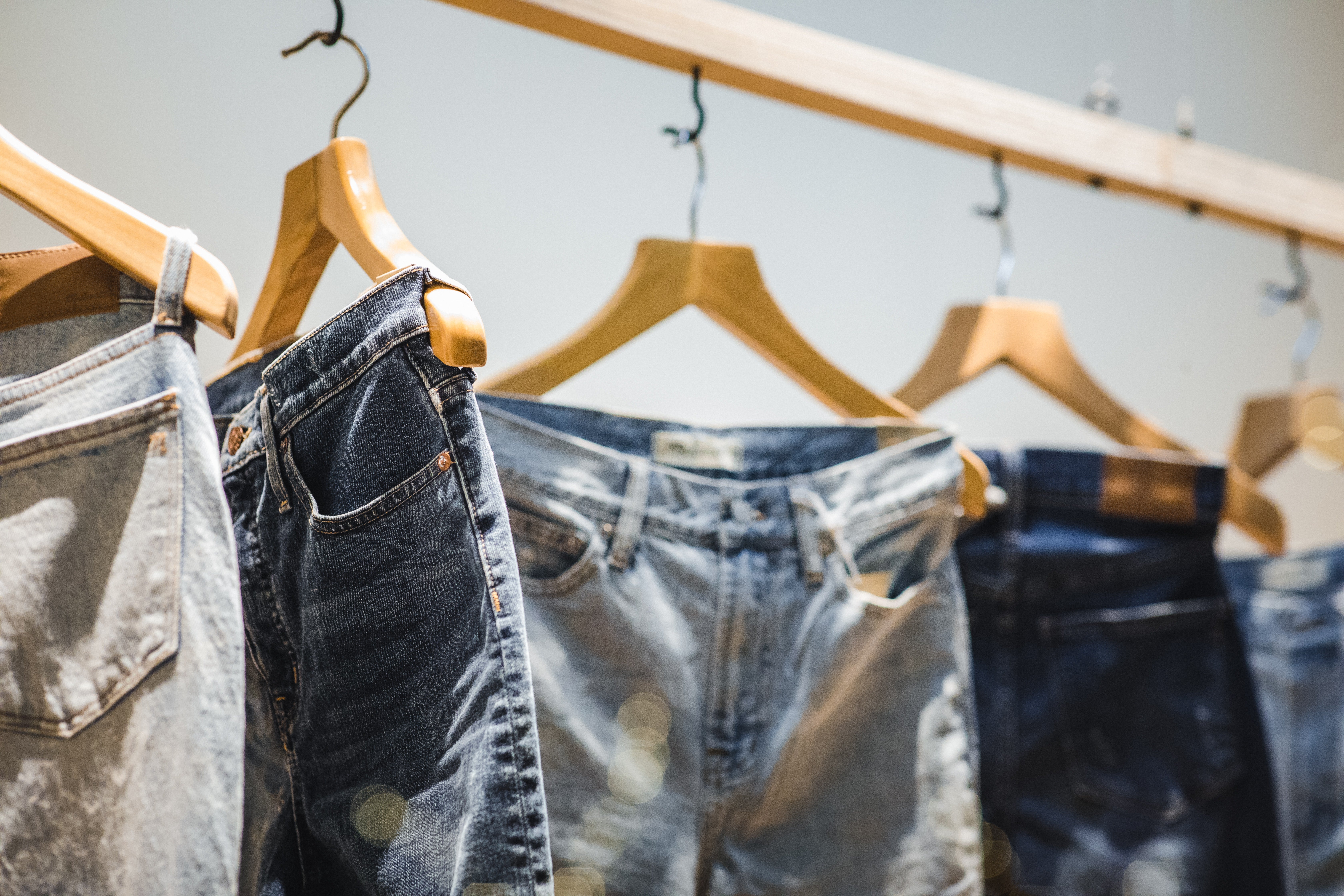 Jeans on a clothing rack. 