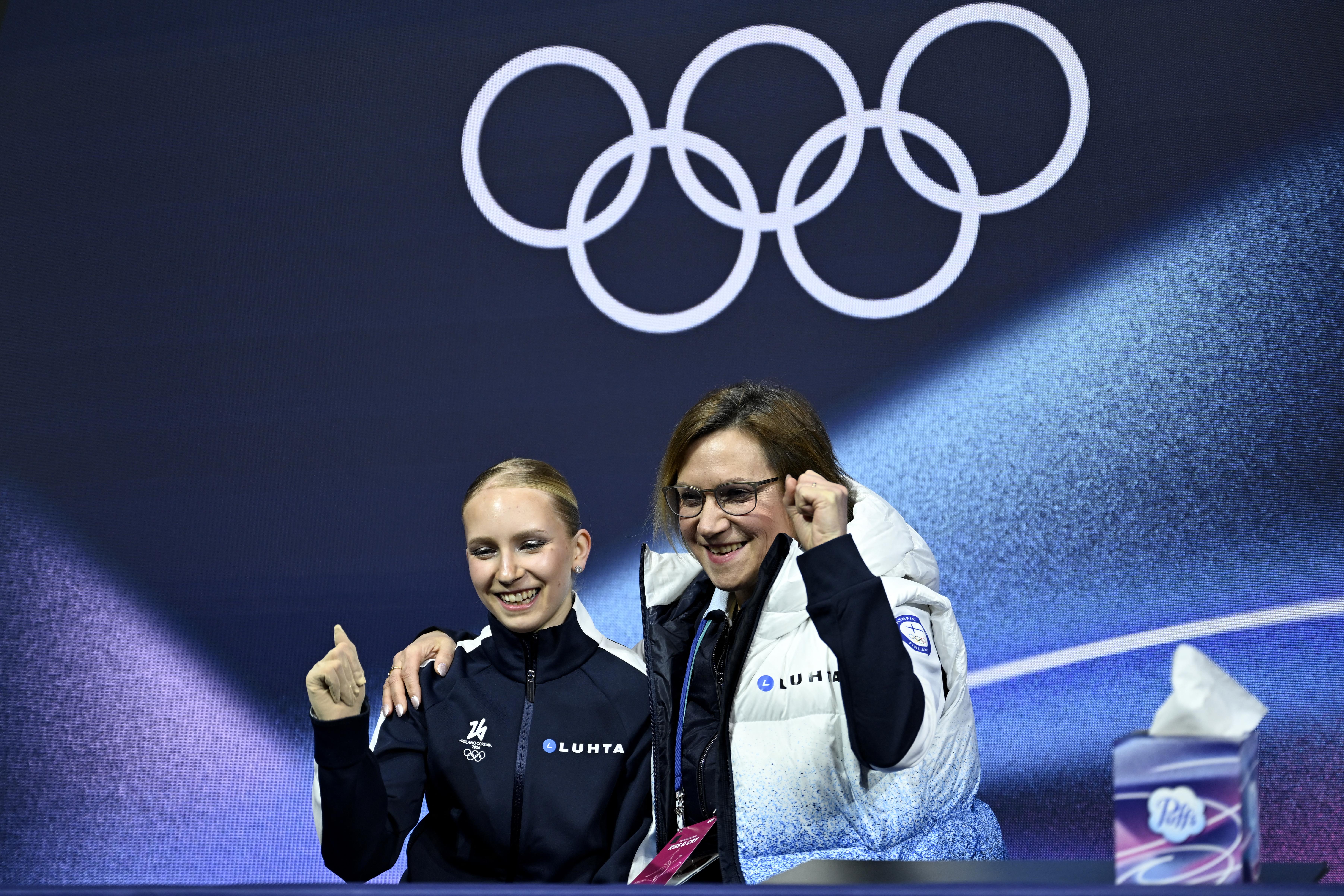 Finland's Iida Karhunen (L) reacts in the kiss and cry area after competing in the figure skating women's single skating short program during the Milano Cortina 2026 Winter Olympic Games at Milano Ice Skating Arena in Milan on February 17, 2026. (Photo by WANG Zhao / AFP via Getty Images)