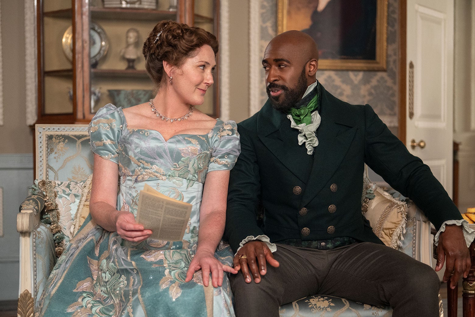 Violet and Lord Anderson seated on a settee together.