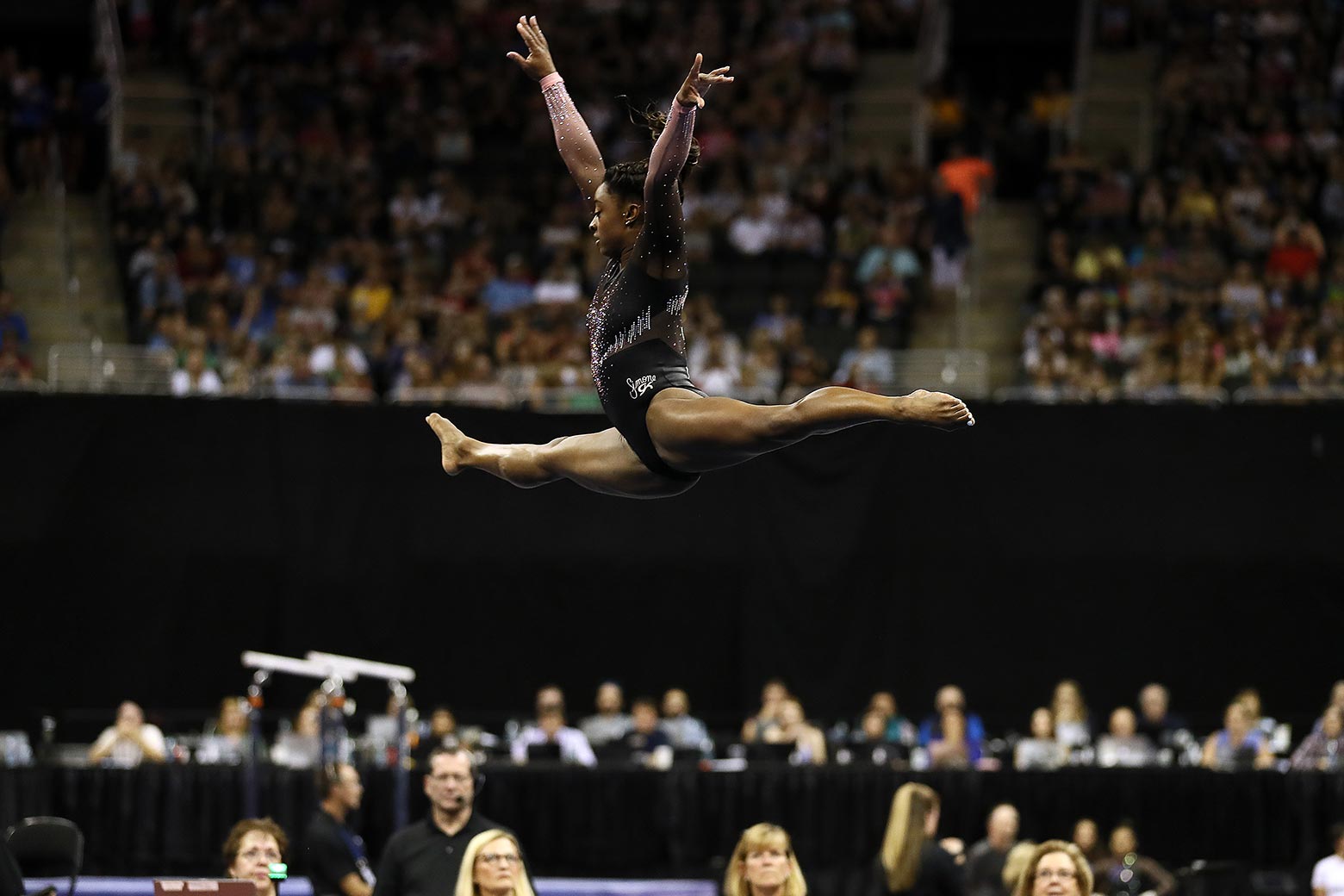 Simone Biles is seen mid-leap during her floor exercise on Sunday in Kansas City.
