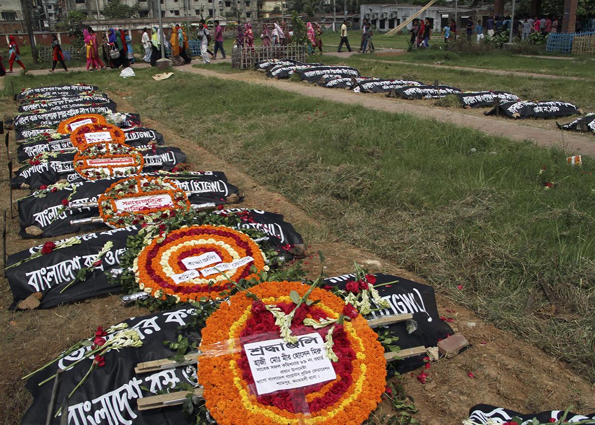 Bangladeshi social acctivists and relatives of victims of the Rana Plaza building collapse pay their respects at a graveyard in Dhaka on April 24, 2016, as they mark the third anniversary of the disaster.